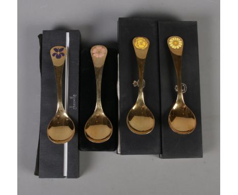 Four Georg Jensen silver gilt year spoons featuring floral enamel decoration. Includes years 1973, 1976, 1977 and 1978.  