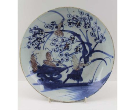 A LATE MING DYNASTY CHINESE CERAMIC PLATE, hand painted bird amidst blossom decoration, in cobalt blue and iron red, 23.5cm i