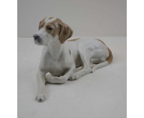 A ROYAL COPENHAGEN PORCELAIN MODEL OF A RECUMBENT POINTER, head alert, modelled by Lauritz Jensen, printed and painted factor
