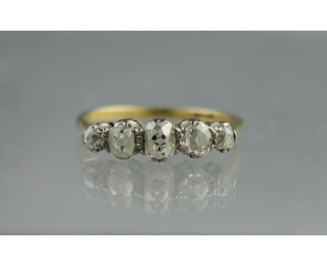 18CT GOLD FIVE STONE DIAMOND RING.  The old cut diamonds graduated in size from the centre and claw set.  Ring size R.(B.P. 2