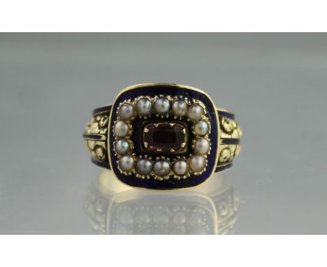 GEORGIAN MOURNING RING decorated with blue enamel inset to the centre with a foiled pink stone surrounded by pearls with engr