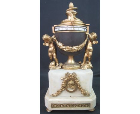 FRENCH ORMOLU AND WHITE MARBLE 'CERCLE TOURNANTS' URN SHAPED, CHERUB MOUNTED MANTEL CLOCK, having horizontal ceramic scales r