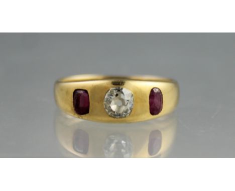 18CT GOLD, DIAMOND AND RUBY RING.  The central old cut diamond set with an oval cut ruby to either side.  Ring size T.(B.P. 2