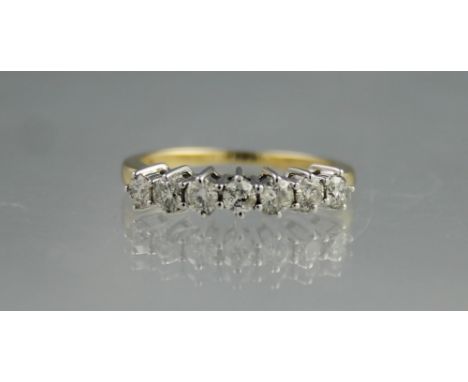 18CT GOLD SEVEN STONE DIAMOND RING.  Ring size N&1/2.(B.P. 24% incl. VAT)