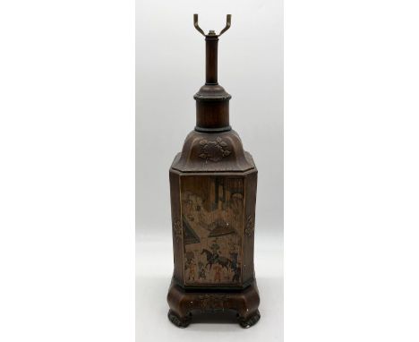 An Oriental pottery lamp base decorated with traditional scenes and raised floral relief  - overall height 60cm 