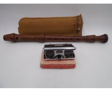 A Kung wooden recorder in case along with a pair of pocket binoculars