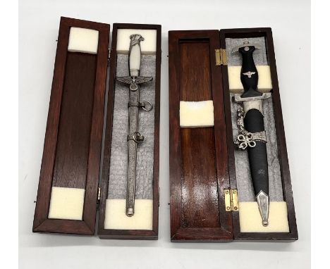 Two cased replica WW2 German daggers including SS dagger and one other