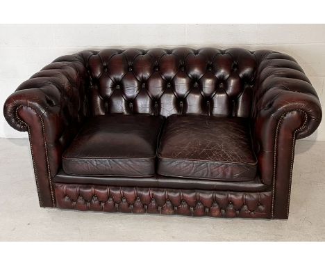 A two seater oxblood Chesterfield leather sofa 