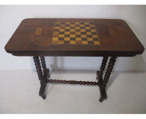 A Victorian games table on bobbin turned legs