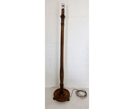 A turned oak standard lamp on bun feet 