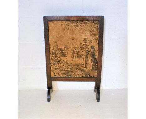 An oak fire screen with tapestry design.
