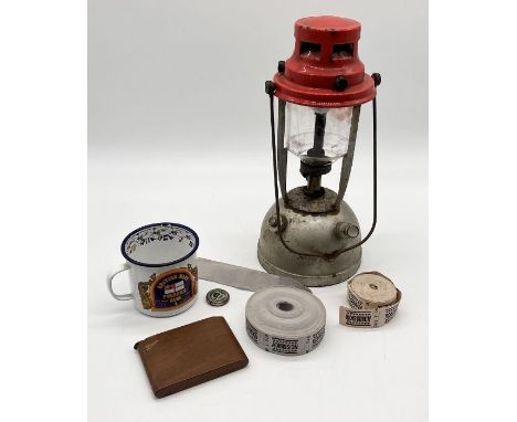 A collection of items including vintage admission tickets, gas lamp, Prusser's enamel rum mug etc.