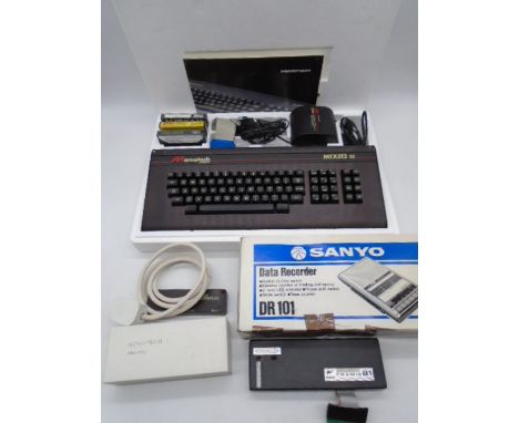 A boxed Memotech MTX512 S2 computer with power supply, memory and other accessories, along with a vintage boxed Sanyo Data Re