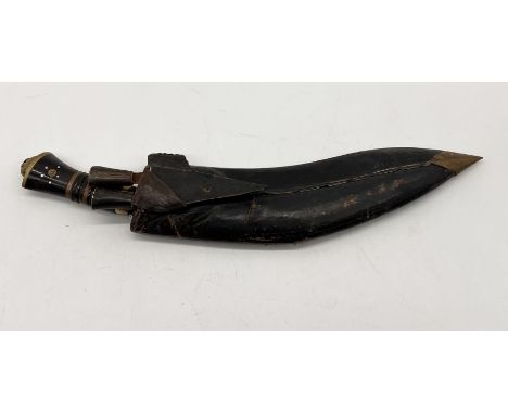 A vintage Kukri with the blade marked "Lai India" in leather scabbard with two smaller skinning knives 