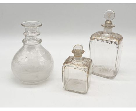 Two antique glass scent bottles with gilt decoration along with an antique etched, ring-necked carafe 