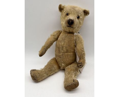 A fully jointed Chiltern teddy bear circa 1930's with elongated nose, stitched nose and paws and canvas pads - length 39cm
