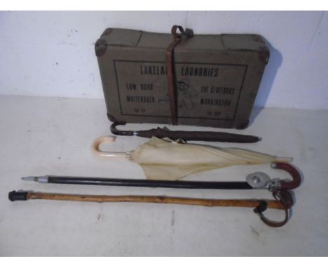 A vintage laundry box along with a shooting stick, walking stick etc.