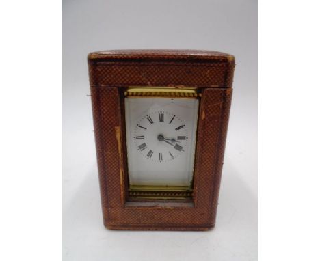 A French brass carriage clock in leather travel case