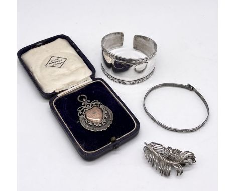 Two silver bracelets, silver medallion and a brooch in the form of a feather, total weight 42g