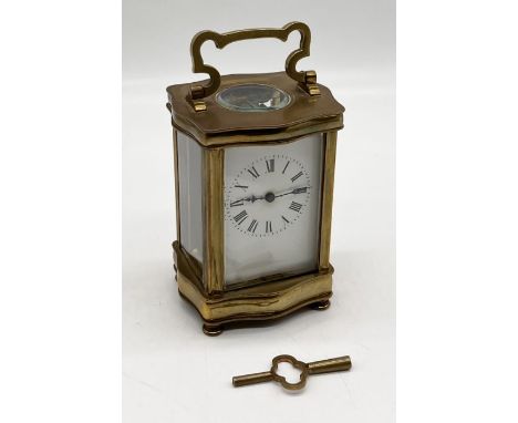 A French carriage clock with Douchine style brass case - hinge on door needs some restoration