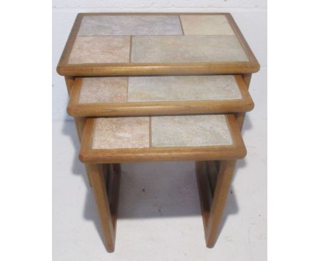 A nest of tile topped coffee tables