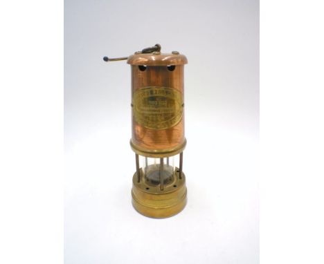 A copper and brass miners lamp.