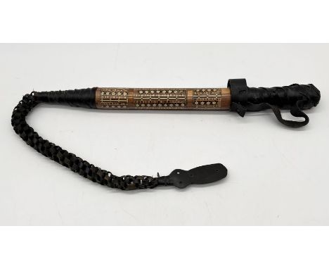 A North African camel drivers whip with inlaid decoration to handle