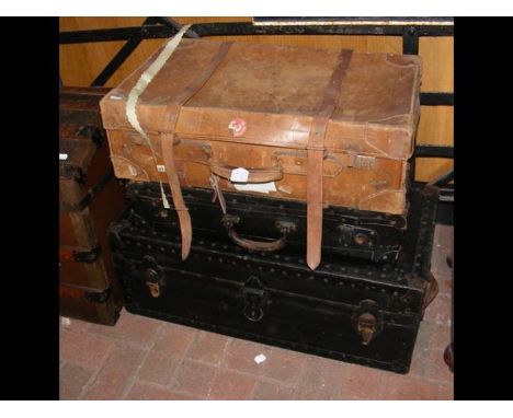 A vintage leather suitcase and one other together with a travelling trunk