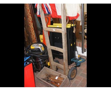 Vintage sack trucks together with old work working tools