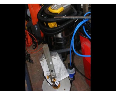 A commercial shop vacuum together with a fret saw (bench mounted)