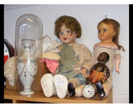 A Pedigree mid 20th century doll, two other dolls, travelling clock and a vase under glass dome