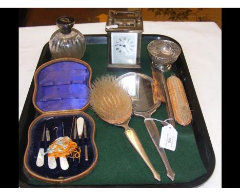 A brass cased carriage clock, silver back dressing table mirror, etc. 