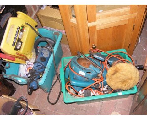 A plastic green container with various electric tools and one other green box 