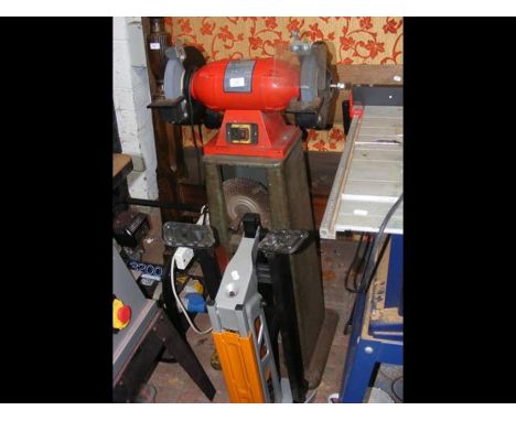 A bench grinder on metal stand together with folding stand