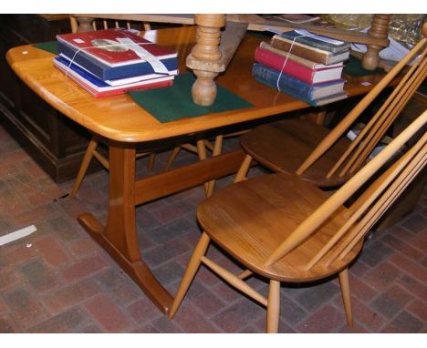 An Ercol 'Light Dawn' dining table with four stick back chairs 