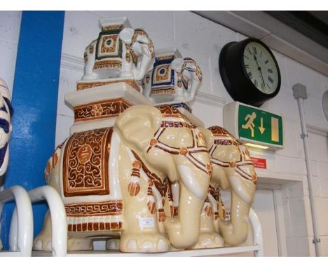A pair of ceramic elephant stools, together with two miniature stools 