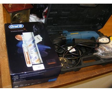 A new electric toothbrush together with cutlery, tools etc