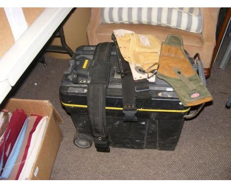 A black plastic toolbox, together with tool belts, etc. 