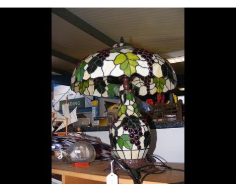 A Tiffany style table lamp with grape design (See also Lot 686) CONDITION REPORTBy our judgement, condition of lot is good.Ou