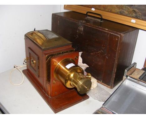 A Victorian magic lantern in carrying case converted to electricity