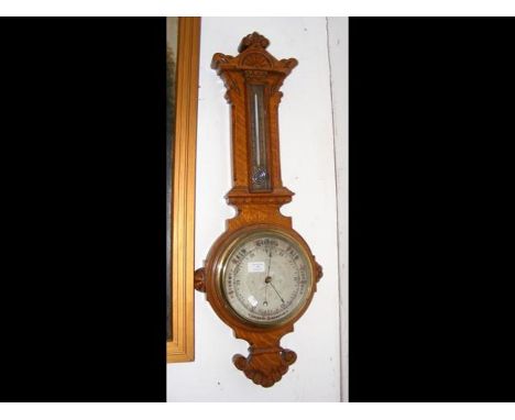 A Victorian oak aneroid barometer/thermomenter 