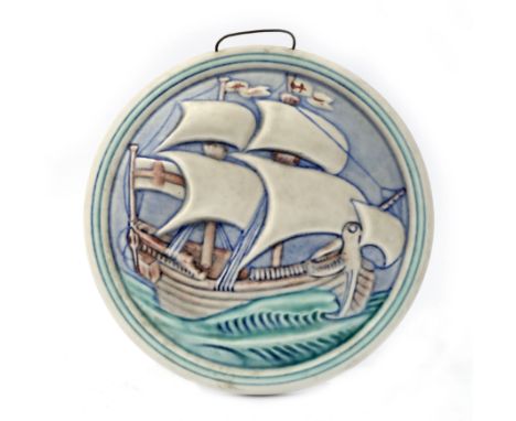 William S Mycock for Pilkington, a Royal Lancastrian relief moulded plaque, circa 1930s, circular with galleon in full sail, 