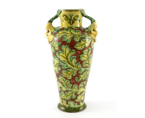 Arthur Bells and Annie Smith for Della Robbia, an art pottery vase, twin handled shouldered form, the handles modelled in rel