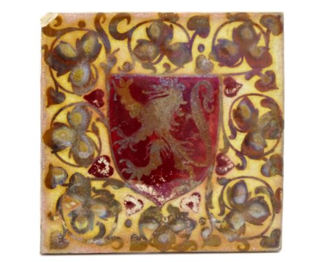 Pilkington, a Royal Lancastrian relief moulded heraldic lustre tile, painted with a red shield with lion rampant, within foli