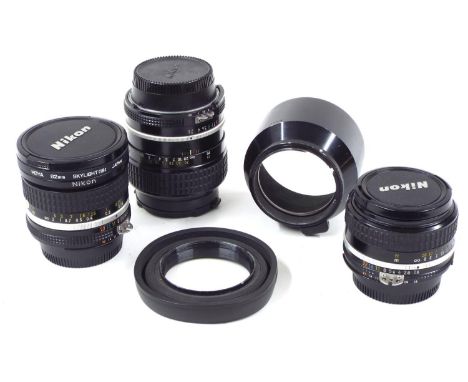 Nikon NIKKOR 105mm 1:2.5 camera lens, serial no. 805936; together with a 50mm 1:1.8 lens no. 3234944 and and a 20mm 1:2.8 no.