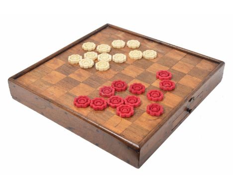 19th century stained ivory draughts set, each piece of lobed circular form finely carved and pierced, within a walnut and ros