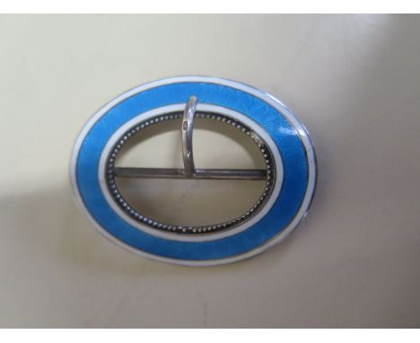 A silver buckle of oval form with blue and white enamel decoration, approx 0.5 troy oz, light wear, enamel in good condition 
