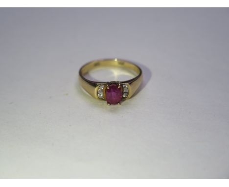 A ruby and diamond 14ct ring flat profile shank and wide shoulders to centre oval mixed cut ruby in four claw setting flanked