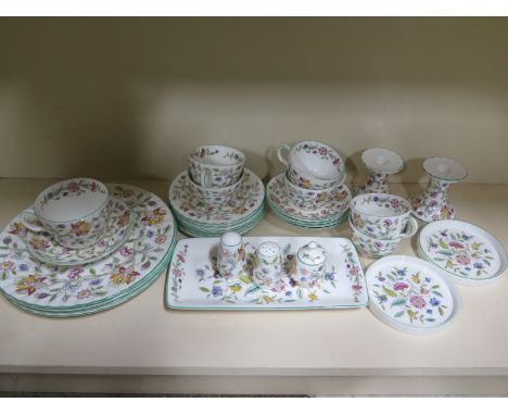 A part Minton Haddon Hall service including - four dinner plates, six tea plate, five saucers, seven cups, two candle holders