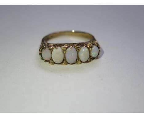 A five stone opal ring, 9ct gold band, largest opal approx 6mm oval. ring size K, approx 6.5 grams, with some wear to gold an